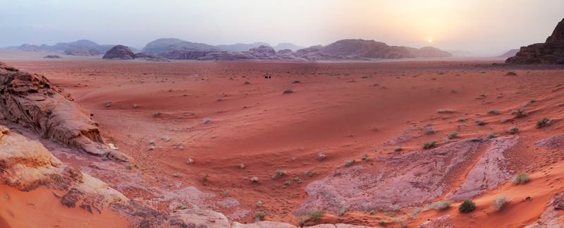 Sunset over the red sand and mountains of Wadi Rum