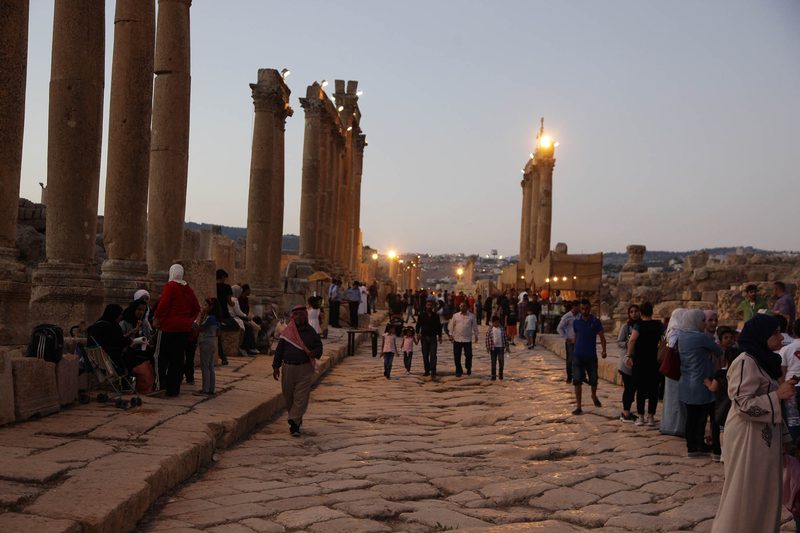 Families walking the colonnaded street at the Jerash Festival