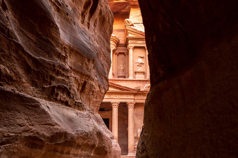 Al-Khazneh, the Treasury of Petra, seen between the rock walls of the Siq
