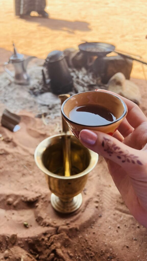 A cup of Arabic coffee poured in the desert